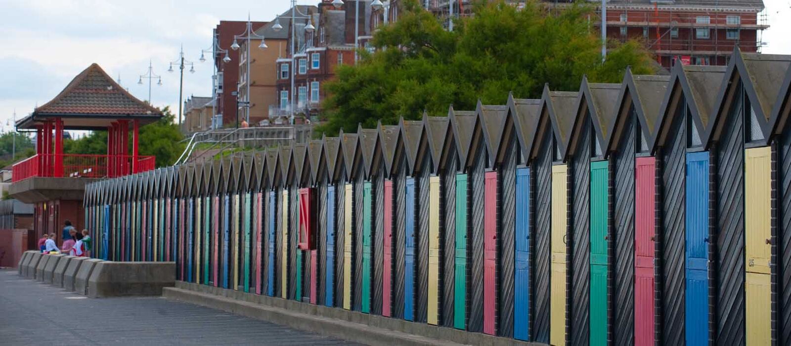 Row of colourful beach huts on an East Anglian promenade