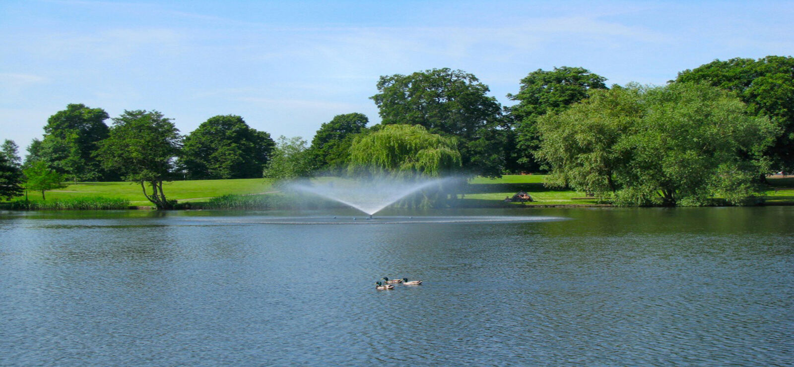 Fountain on a tree-lined mere in East Anglia