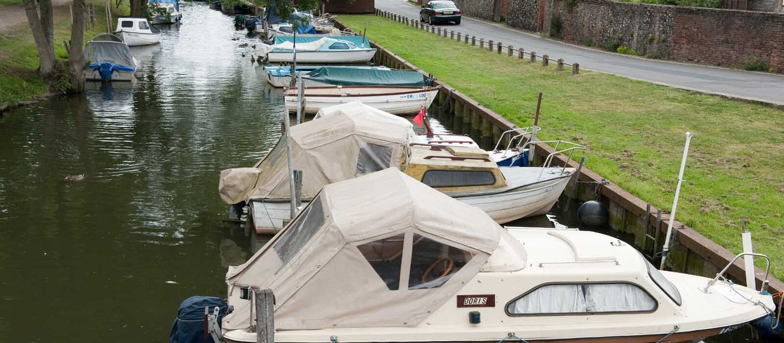 Boats moored along a quiet river