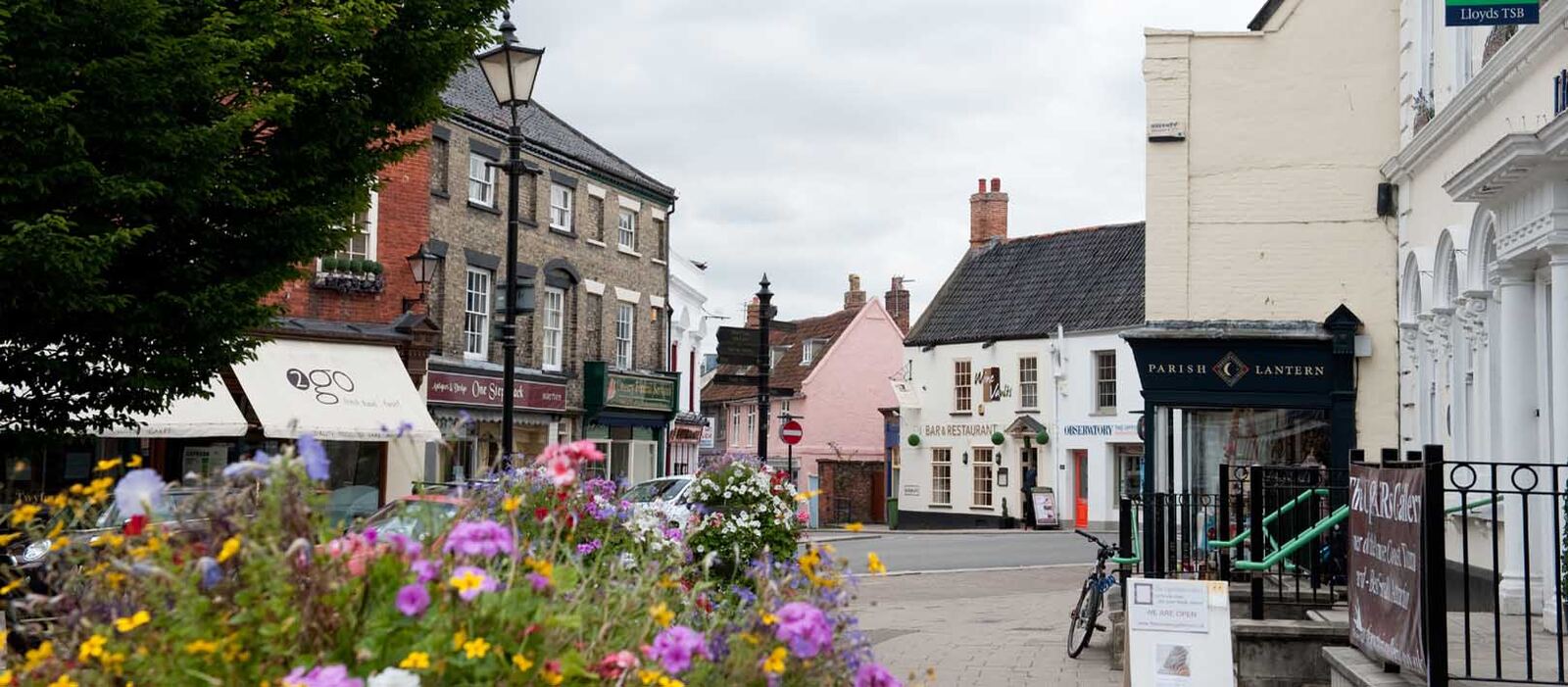 Flower beds and shopfronts in a Norfolk market town